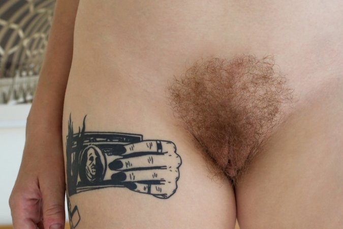 Ginger girl excitingly poses and strokes hairy pussy photo 12